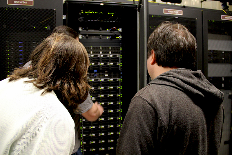 CHPC Senior IT Architect Brian Haymore shows Lexie Wilson and Chris Pennell of the Utah Division of Air Quality the nodes that store and model the state agency's data during a tour of the Downtown Data Center on April 5, 2019.