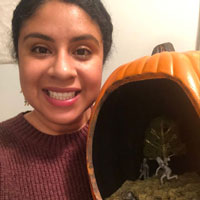 Shenia Sellers takes a photo with her "Zombie graveyard pumpkin diorama 🧟‍♀️"