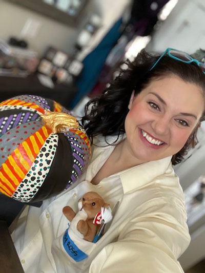 Emily Jacoby, dressed as "Betsy Ross," poses with her patchwork pumpkin.