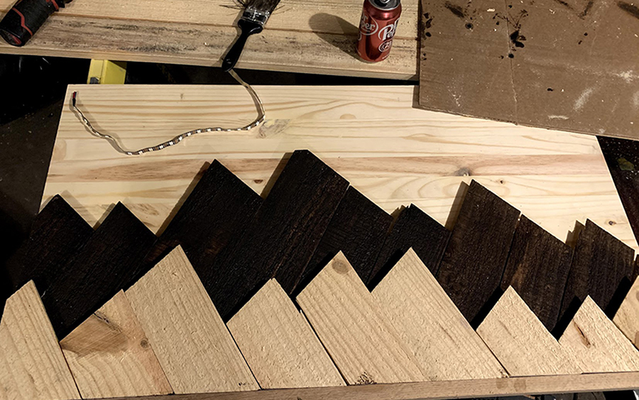 Harris reproduced some wood wall art that he admired by cutting some scrap wood strips to resemble the silhouette of a mountain, then backing them with LED lights.