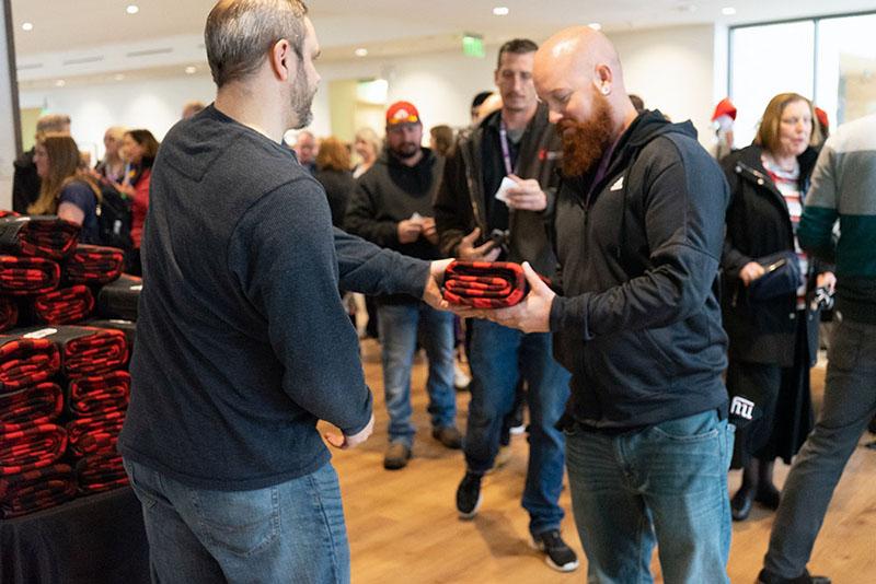 The UIT Holiday Luncheon in December of 2019 included doorbuster gifts of U-themed roll-up stadium blankets.