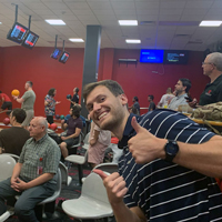 Keegan Spencer gives two thumbs up as UIT employees bowl September 1, 2022, at the A. Ray Olpin Union bowling alley.