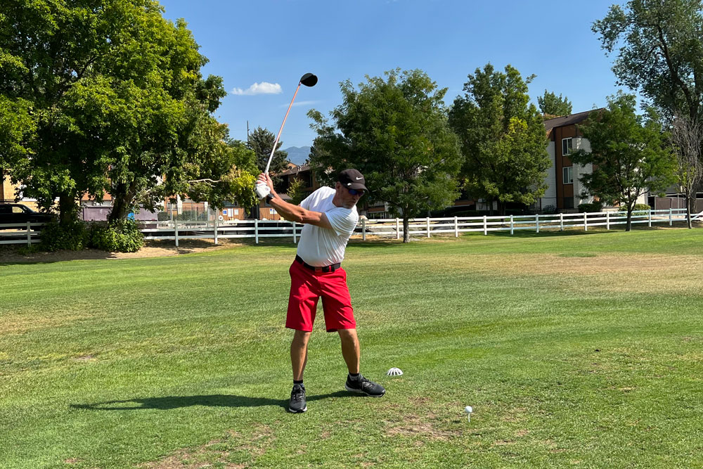 Mark Curtz swings his golf club to make a shot.