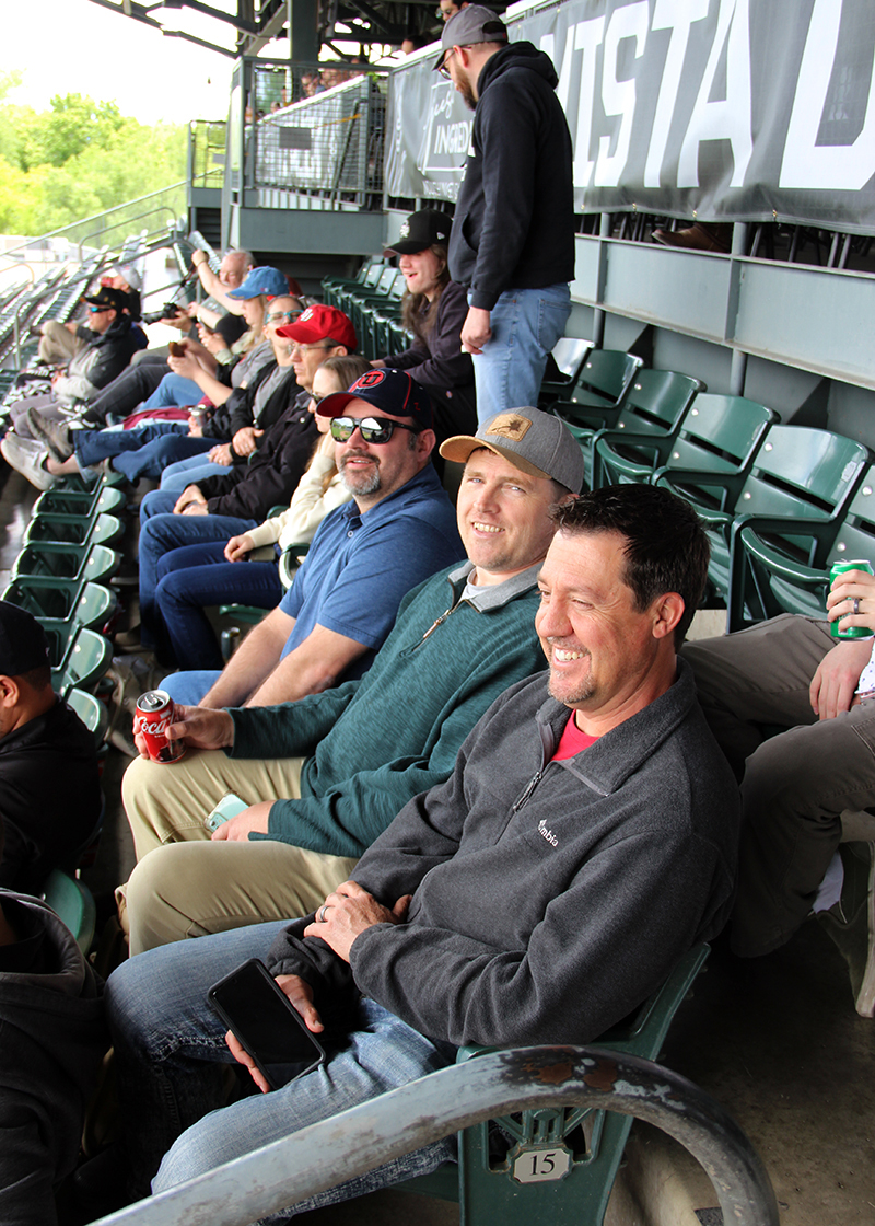 UIT employees enjoy the game from their seats below the Vista Deck at Smith's Ballpark, site of the 2024 UIT Spring Party.