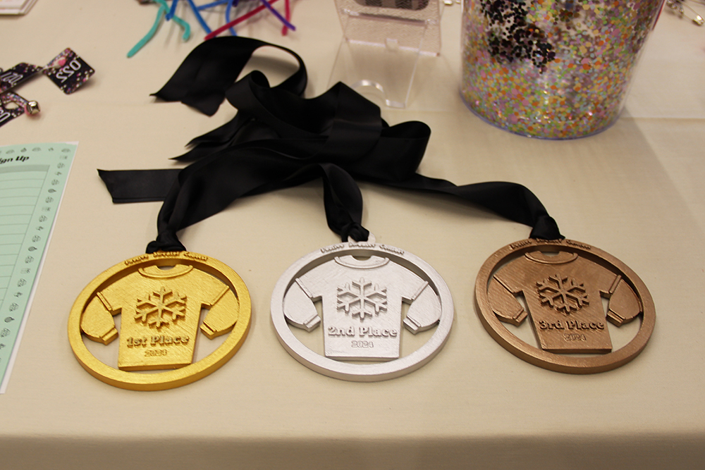    3D printed medals were awarded to the festive holiday sweater contest winners