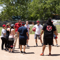 The USS and UIT SPS teams meet during the kickball game. (Photo by Thanh Nguyen)