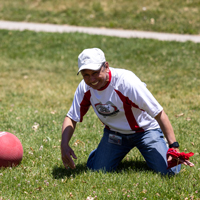 Ray Lacanienta (USS) laughs while kneeling beside the ball on the ground. (Photo by Thanh Nguyen)