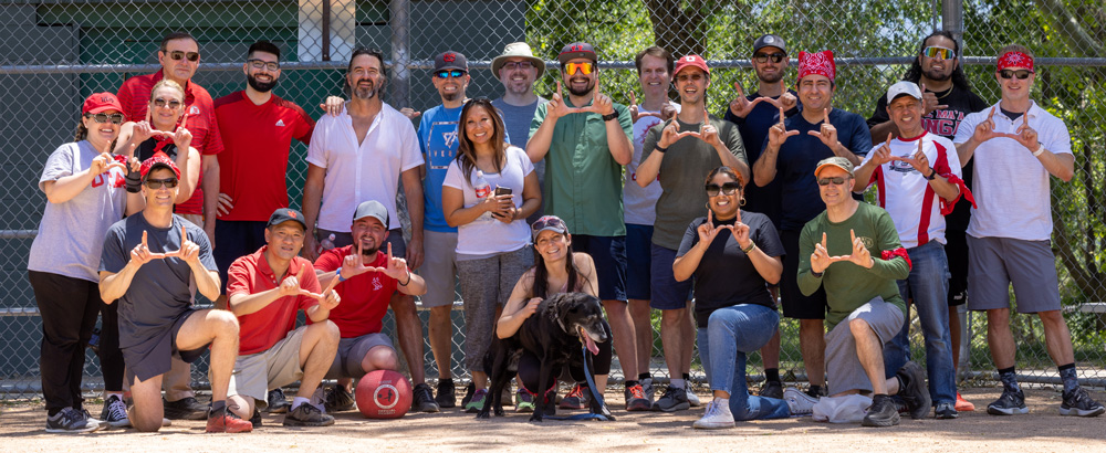 Employees from Software Platform Services (SPS), University Support Services (USS), Student University Development Opportunity (SUDO), and a couple of other UIT teams pose for a photo at the USS-SPS kickball game on June 23, 2022. (Photo by Thanh Nguyen)