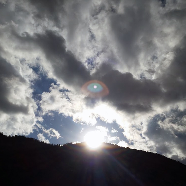The sun peeks over the mountain at Alta Ski Area.