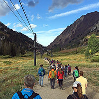 TreeUtah volunteers walk to the Collins ski lift.